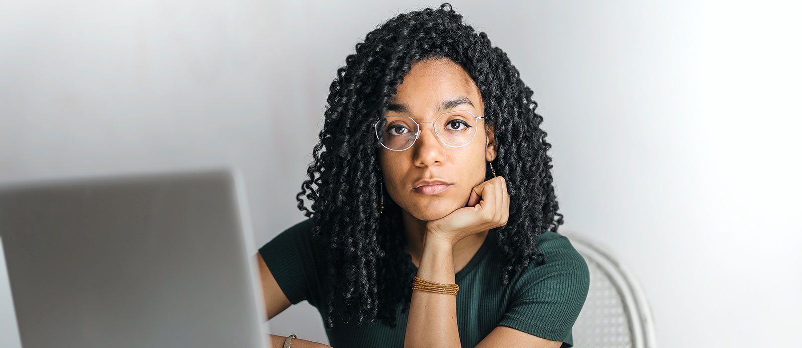 Black student at their computer working from home.